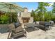 Charming outdoor fireplace with stone surround and comfortable seating, perfect for cozy evenings outdoors at 1149 Grand Oak Dr, Waxhaw, NC 28173