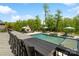 Beautiful backyard with a swimming pool, outdoor fireplace, comfortable seating, and lush landscaping at 1149 Grand Oak Dr, Waxhaw, NC 28173