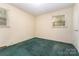 Cozy bedroom with green carpet and a large window providing ample natural light at 1214 Short St, Salisbury, NC 28144