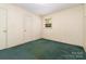 Bedroom featuring green carpeting, neutral walls, and a window with natural light at 1214 Short St, Salisbury, NC 28144