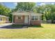Exterior of a small single-story brick house with a covered porch and a green lawn at 1214 Short St, Salisbury, NC 28144