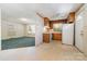 Eat-in kitchen featuring wood cabinets, white appliances, linoleum floors, and natural light from the adjacent room at 1214 Short St, Salisbury, NC 28144