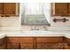 Close-up of a double basin kitchen sink with wood cabinets, and a large window above it at 1214 Short St, Salisbury, NC 28144