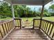 Back porch with stairs leading to spacious, tree-lined backyard at 1224 Bailey St, Albemarle, NC 28001