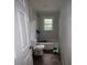 Small and basic bathroom with white toilet, shower, and window letting in natural light at 1224 Bailey St, Albemarle, NC 28001