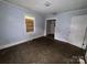 A small blue bedroom with tile floors, a window, and a door leading to a closet at 1224 Bailey St, Albemarle, NC 28001