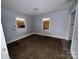 Vacant bedroom featuring light blue walls, tile floors, and natural light from two windows at 1224 Bailey St, Albemarle, NC 28001