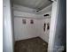Small bedroom closet with basic shelving, linoleum floors, and light from adjacent room at 1224 Bailey St, Albemarle, NC 28001
