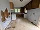 This worn kitchen features an electric stove, orange backsplash, and outdated wooden cabinets at 1224 Bailey St, Albemarle, NC 28001