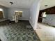 View from the front room towards the kitchen, which features vintage details and peeling paint at 1224 Bailey St, Albemarle, NC 28001