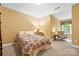Cozy bedroom with a patterned comforter, soft lighting, and a comfortable chair by the window at 1244 Saint Johns Ave, Matthews, NC 28104