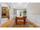 Bright dining room featuring wood table and chairs, elegant wainscoting, and a decorative area rug at 1244 Saint Johns Ave, Matthews, NC 28104