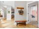 Welcoming entryway with a wooden bench, coat hooks, and hardwood floors leading to other rooms at 1244 Saint Johns Ave, Matthews, NC 28104