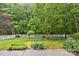 Well-manicured front yard with lush green grass and a white picket fence, creating a welcoming curb appeal at 1244 Saint Johns Ave, Matthews, NC 28104