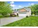 Charming home featuring a manicured lawn, mature trees, and a two-car garage, creating a welcoming curb appeal at 1244 Saint Johns Ave, Matthews, NC 28104