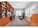 Inviting home office with custom built-ins, a comfortable seating area, and ample natural light for a productive workspace at 1244 Saint Johns Ave, Matthews, NC 28104