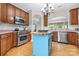 Well-equipped kitchen with stainless steel appliances, a center island, and ample cabinet space, perfect for cooking at 1244 Saint Johns Ave, Matthews, NC 28104