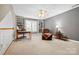 Upstairs loft area featuring built in bookshelves, ample light, and comfortable chair at 1244 Saint Johns Ave, Matthews, NC 28104