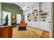 Inviting home office with built-in bookshelves, comfortable seating, and ample natural light at 1244 Saint Johns Ave, Matthews, NC 28104