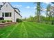 Expansive backyard featuring a manicured lawn and privacy fencing, perfect for outdoor activities at 13106 Bien Ct, Huntersville, NC 28078