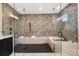 Spa-like bathroom with glass-enclosed shower, soaking tub, and designer tile for a luxurious experience at 13106 Bien Ct, Huntersville, NC 28078