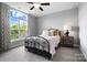 Bedroom featuring a metal bed frame, neutral colors, and a large window with natural light at 13106 Bien Ct, Huntersville, NC 28078