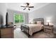 Cozy bedroom with a metal bed frame, ceiling fan, and a view of the outdoors at 13106 Bien Ct, Huntersville, NC 28078