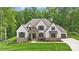 Stunning exterior of a two-story home with stone accents, neutral stucco, and a professionally landscaped yard at 13106 Bien Ct, Huntersville, NC 28078