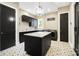 Well-designed laundry room boasts a marble island, modern appliances, and stylish patterned floors at 13106 Bien Ct, Huntersville, NC 28078