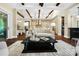 Open-concept living room with exposed beams, dark wood floors, and an elegant, neutral color palette at 13106 Bien Ct, Huntersville, NC 28078