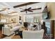 Spacious living room featuring exposed beams, hardwood floors, and an open layout to the kitchen at 13106 Bien Ct, Huntersville, NC 28078