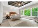 Bright main bedroom features a trey ceiling, a large window and a neutral color palette at 13106 Bien Ct, Huntersville, NC 28078
