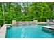 Inviting pool with water features and a lush, green backdrop, perfect for relaxation and recreation at 13106 Bien Ct, Huntersville, NC 28078