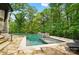Beautiful pool with built-in waterfalls and stone surround, creating a tranquil outdoor oasis at 13106 Bien Ct, Huntersville, NC 28078
