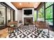 Inviting sunroom with fireplace, stone flooring, and stylish furnishings, perfect for relaxation and entertaining at 13106 Bien Ct, Huntersville, NC 28078