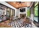 Inviting sunroom with fireplace, stone flooring, and stylish furnishings, perfect for relaxation and entertaining at 13106 Bien Ct, Huntersville, NC 28078