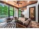 Inviting sunroom with fireplace, stone flooring, and stylish furnishings, perfect for relaxation and entertaining at 13106 Bien Ct, Huntersville, NC 28078