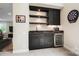 A sleek wet bar in the basement boasts dark cabinetry, open shelving, and a wine fridge at 13106 Bien Ct, Huntersville, NC 28078