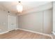 This is a brightly lit bedroom with hardwood floors and modern lighting fixture at 1320 Fillmore Ave # 112, Charlotte, NC 28203