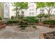 Picturesque courtyard with manicured gardens, trees, and stone accents at 1320 Fillmore Ave # 112, Charlotte, NC 28203