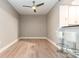 Bright dining area with hardwood floors, white bar stools, and modern ceiling fan at 1320 Fillmore Ave # 112, Charlotte, NC 28203
