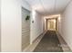 Well-lit hallway with gray doors and a carpet runner, creating an inviting and clean passage at 1320 Fillmore Ave # 112, Charlotte, NC 28203