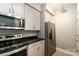 Modern kitchen featuring stainless steel appliances and granite countertops with stylish cabinets at 1320 Fillmore Ave # 112, Charlotte, NC 28203