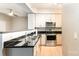Modern kitchen featuring stainless steel appliances, black countertops, and ample cabinet space at 1320 Fillmore Ave # 112, Charlotte, NC 28203