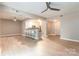 Open-concept living room with light wood floors, bar seating, and a view into the modern kitchen at 1320 Fillmore Ave # 112, Charlotte, NC 28203