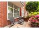 Private outdoor patio with chairs, small table, and garden area at 1320 Fillmore Ave # 112, Charlotte, NC 28203