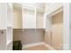 This is a walk-in closet with shelving and metal closet rods at 1320 Fillmore Ave # 112, Charlotte, NC 28203