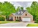 Charming brick home with a well-manicured lawn, dormer windows, and an attached garage at 1342 Crown Ridge Dr # 38, Fort Mill, SC 29708