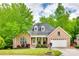 Charming brick home featuring a well-manicured lawn, mature trees, and a two-car garage at 1342 Crown Ridge Dr # 38, Fort Mill, SC 29708