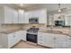 This kitchen features white cabinetry, stainless steel appliances, and granite countertops at 1342 Crown Ridge Dr # 38, Fort Mill, SC 29708